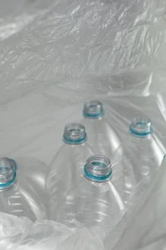 Inside an open transparent plastic bag with several empty bottles of liter an Stock Photos