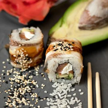 Inside-out Sushi roll with eel decorated with sesame seeds. Sushi Set. Classic Stock Photos