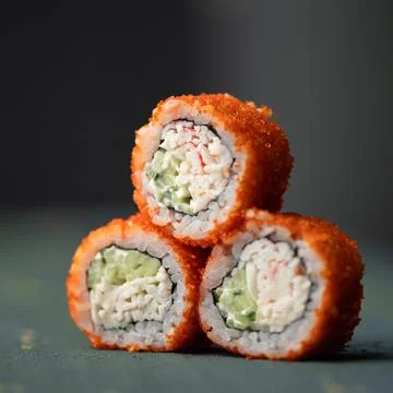 Inside-out Sushi Set. Pyramid of three sushi. Rolls in masago or tobiko caviar Stock Photos