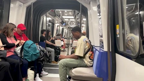 Inside Paris Metro Subway train cabin with passengers seated sitting standing Video stock 281344524