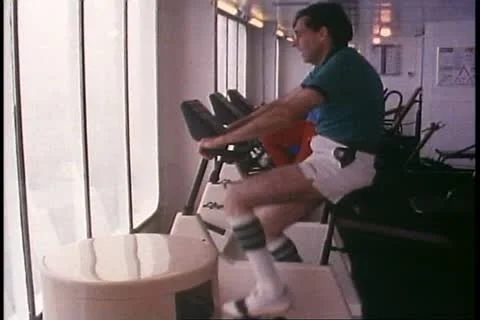 INSIDE PASSAGE, ALASKA, 1989, Exercise bike, gym of a cruise ship, Alaska Cruise Stock Footage 12146522