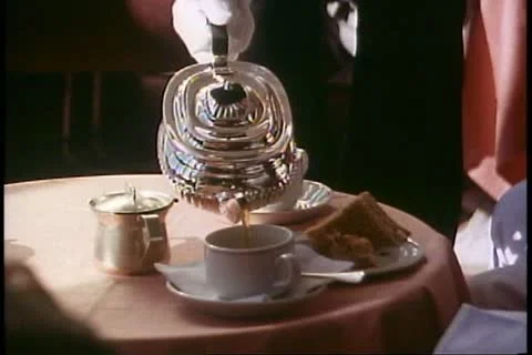 INSIDE PASSAGE, ALASKA, 1989, Tea time, pour tea, silver teapot on Alaska Cruise Video stock 12149098
