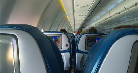 Inside the passenger plane. People are siting on passenger seats of aircraft Stock Footage 201695530