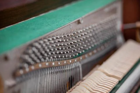 The inside of the piano is without a lid. Strings, hammers and parts Stock Photos