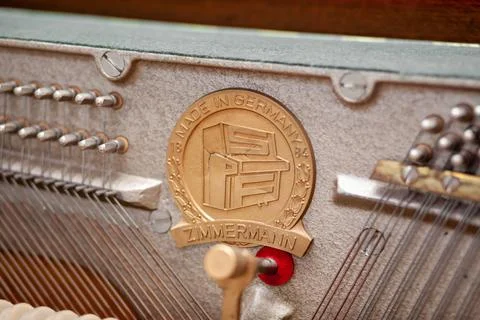 The inside of the piano is without a lid. Strings, hammers and parts Stock Photos