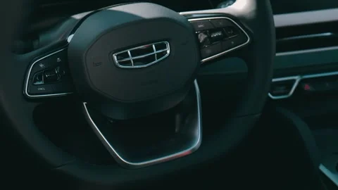Inside the premium Chinese crossover Geely. Close-up of steering wheel and dashb 스톡 동영상 240456281