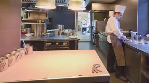 Inside a professional kitchen with time lapse view of preparing and plating Stock Footage 33730540