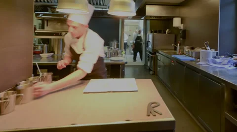 Inside a professional kitchen with time lapse view of chefs plating dishes Stock Footage 33730997