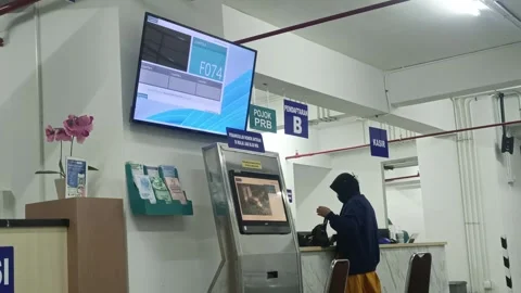 Inside public service facility showcasing modern queue management and infor.. Stock Footage 303831320