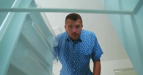 Inside refrigerator. Man open fridge with empty shelves have nothing to eat. Video stock 250096593