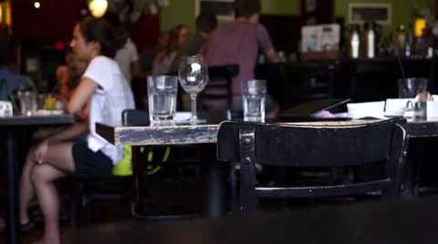 Inside a restaurant focusing on a table with patrons in the background Stock Footage 53285032