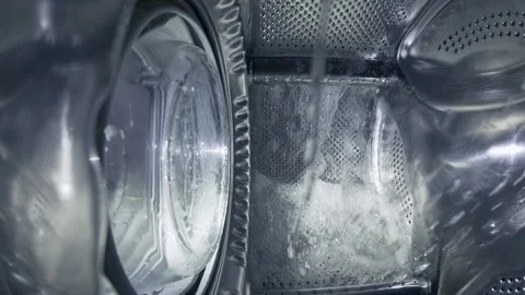 Inside a Rotating Washing Machine Drum with Water Spraying Video stock 332908759