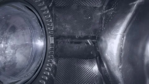 Inside a Rotating Washing Machine Drum with Water Spraying Stock-Footage 332909094