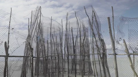Inside a rustic structure of a fishing corral, low tide Stock Footage 233191208