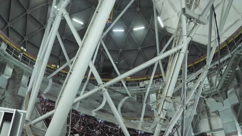 Inside SALT telescope, tilt from primary mirror array up to domed roof Stock Footage 254769822