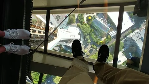 Inside Seattle space needle looking down at feet Stock Footage