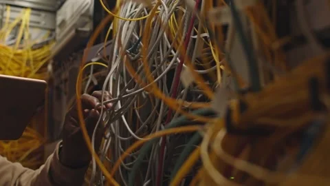 Inside a Server Room IT Engineer Managing Tangled Network Cables Stock Footage 321663846