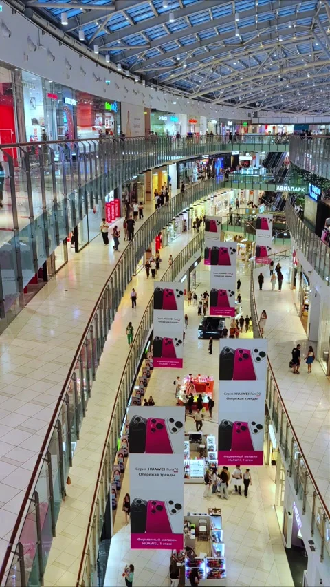 Inside a shopping mall Aviapark. Several floors, escalators, a crowd of people. Stock Footage 280667870