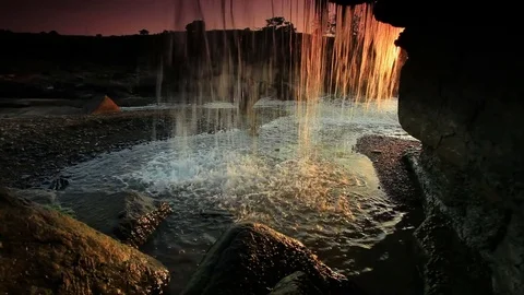 Inside shot of a waterfall at sunset Stock Footage 74073688