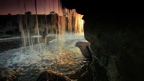 Inside shot of a waterfall at sunset Stock Footage 74073693