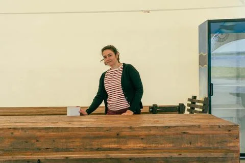 Inside a spacious tent pavilion, an empty counter awaits guests as a confiden Stock Photos