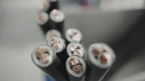 Inside structure of electrical cables, revealing copper wire elements in prod Stock Footage 319503834