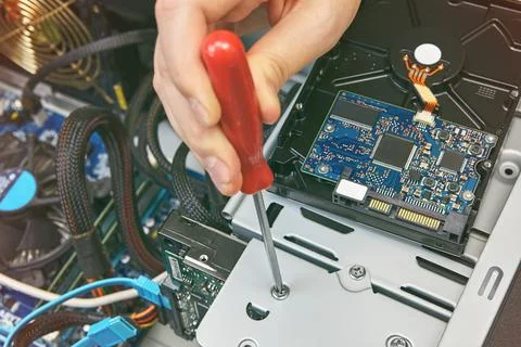 Inside system unit of computer, HDD is fixed with screw. Stock Photos
