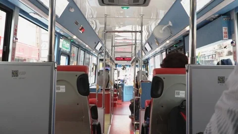 Inside of Taiwanese bus with passengers and commuters boarding and sitting Stock Footage 107033167