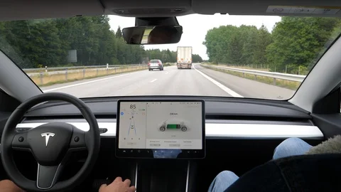 Inside a Tesla Model 3 on auto pilot Stock Footage 112030355