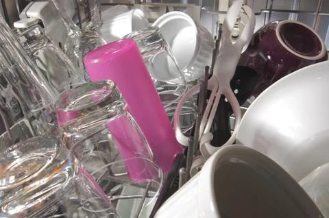 Inside top drawer of a full clean dishwasher Stock Photos