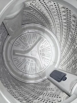 Inside top load washing machine with empty drum Stockfoto's