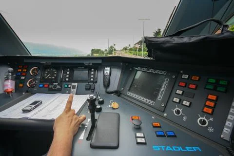 Inside the train cabin with a train driver in operation while driving Stock Photos