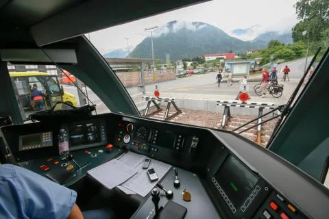 Inside the train cabin with a train driver in operation while driving Stock Photos