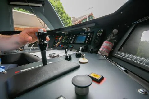 Inside the train cabin with a train driver in operation while driving Stock Photos