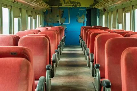 The inside of a train car is empty and mostly red Stock Photos