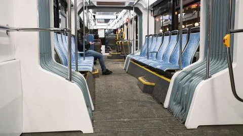 Inside the tram in the evening. One passenger Stock Photos
