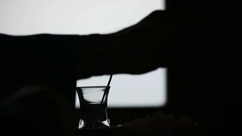 Inside a Turkish cafe: Making a hot tea cup in front of a window, silhouette Video stock 119907423