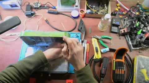 Inside Ukraine's drone workshops: A soldier builds vital electronics for the Stock Footage 313324027