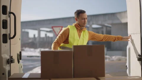 Inside the van POV - Delivery man opening both doors grabbing a parcel  Stock Footage 263896401