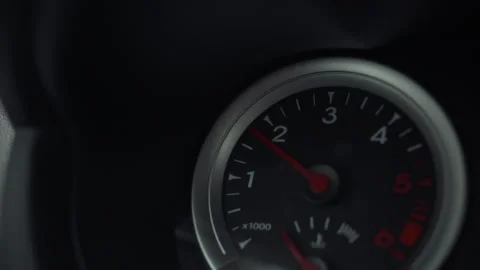Inside the vehicle the dashboard instrument panel displays a tachometer gaug Stock Footage 331354035