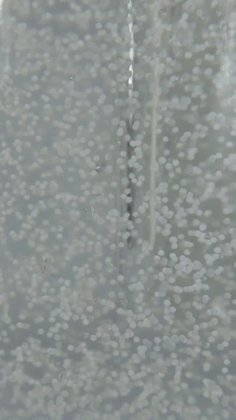 Inside view of the bottle. Air bubbles rising in a beauty product Stock Footage 329643944