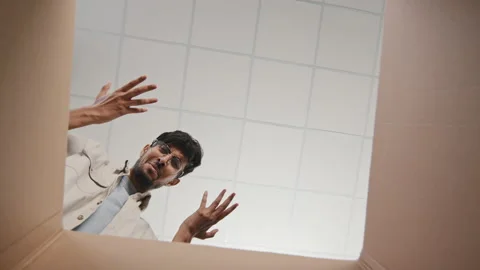 Inside view of box young Hispanic Arab man with glasses guy recipient opens Video stock 166631803