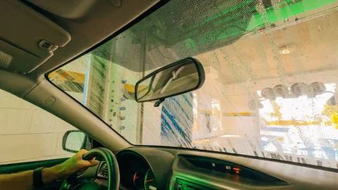 Inside view of a car being washed, with suds and water covering the glass. Stock-Fotos