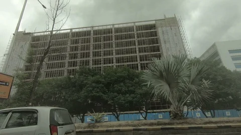 Inside-view-from-car-large-building-under-construction Stock Footage 93450175