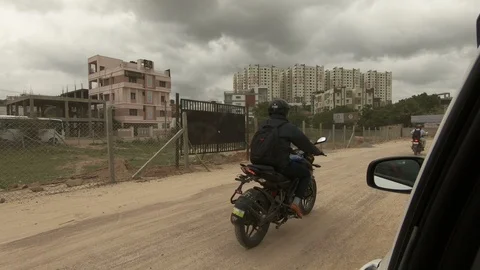 Inside-view-from-car-motorist-riding-on-mud-road-India-cloudy-sky Stock Footage 93450062
