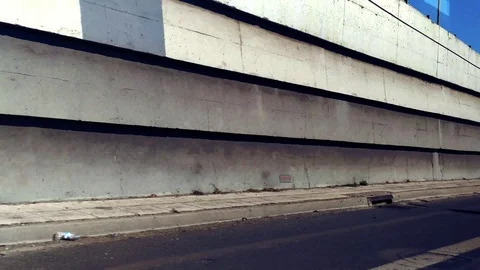 Inside View of Car Running by Concrete Wall Stock Footage 117135879