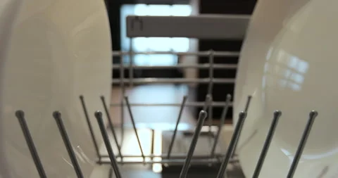 Inside view, close-up the dishwasher door opens hands load dirty dishes into a Stock Footage 261024530