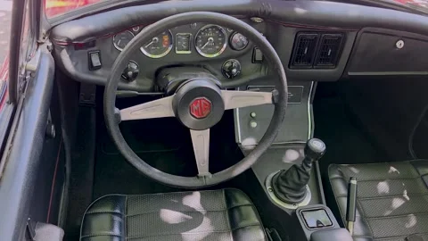 Inside view closeup of a classic vintage MG sports car interior with driver' Stock Footage 337589737