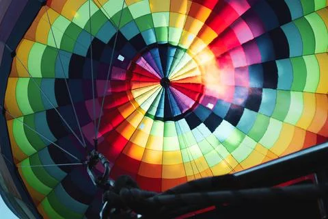 Inside view of colorful rainbow pattern hot air balloon with flame Stock Photos
