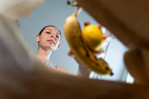 Inside view of craft paper bag with woman puts food in it. Food take away Stock Photos